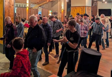Guests of all ages learn a line dance during a Two Right Feet lesson at Thunderhead Lodge.